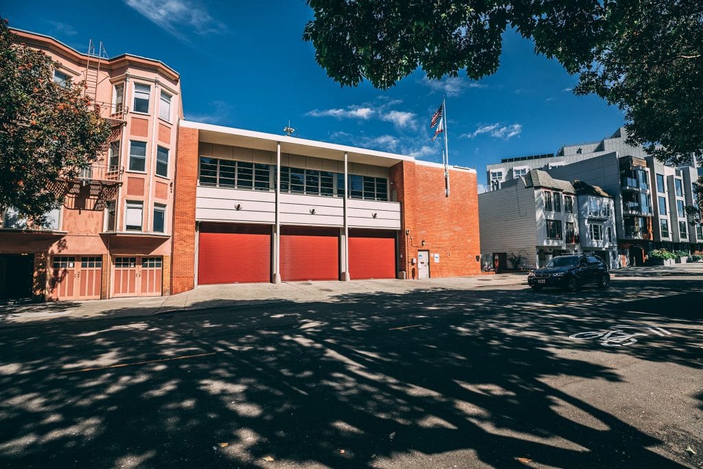 Fire house in San Francisco with new red steel rolling doors
