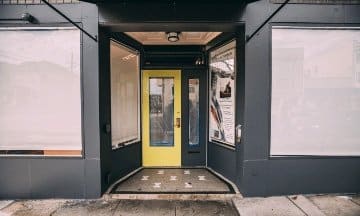 Yellow entrance door installed by Union Door