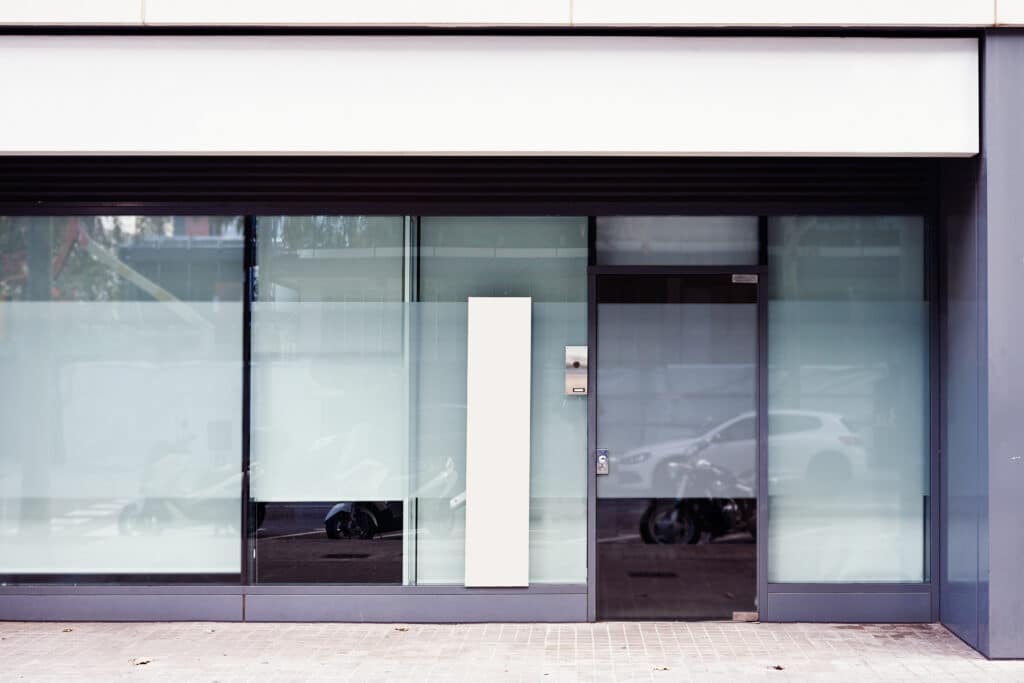a secure glass commercial pedestrian door facing a public street